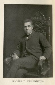 Portrait of man sitting in a wooden chair.