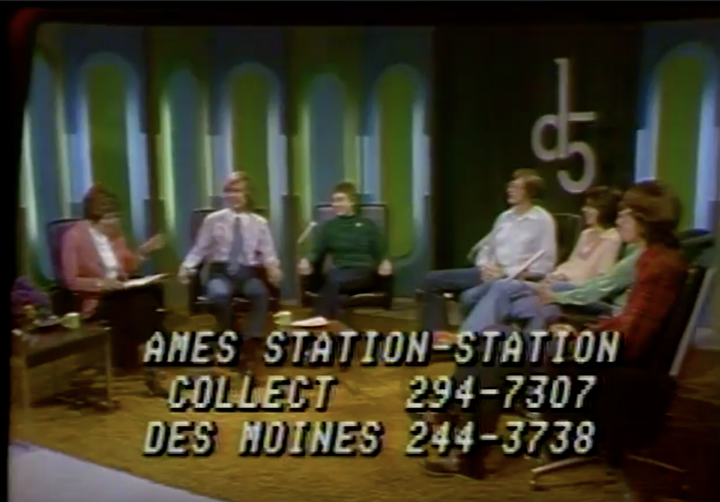 Screenshot from the video entitled Dimension 5: Gay People Alliance, time 1:39. Carolyn Czerna, Karen Moore, Kay Scott, Connie Tanzo, Steve Court, Jim Osler, David Windom, and Dennis Brumm being introduced. Follow the URL in the caption to see this moment in the video.