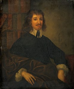 Portrait in dark tones of a man seated in a chair with long hair, a black shirt and a high white collar.
