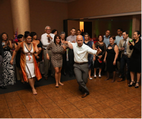 A group of people dancing Bomba at a birthday party