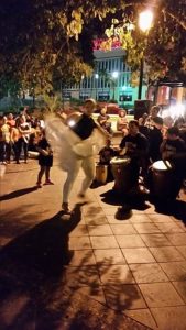 Person dancing Bomba at a public gathering at night