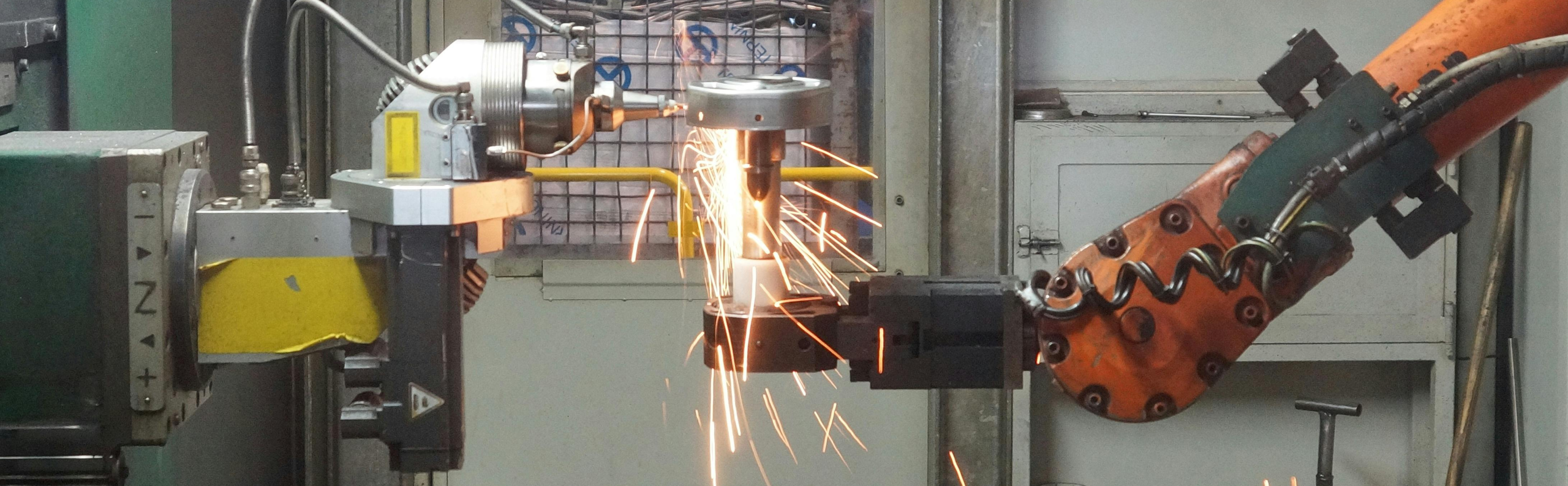 A robotic industrial machine grinding steel.
