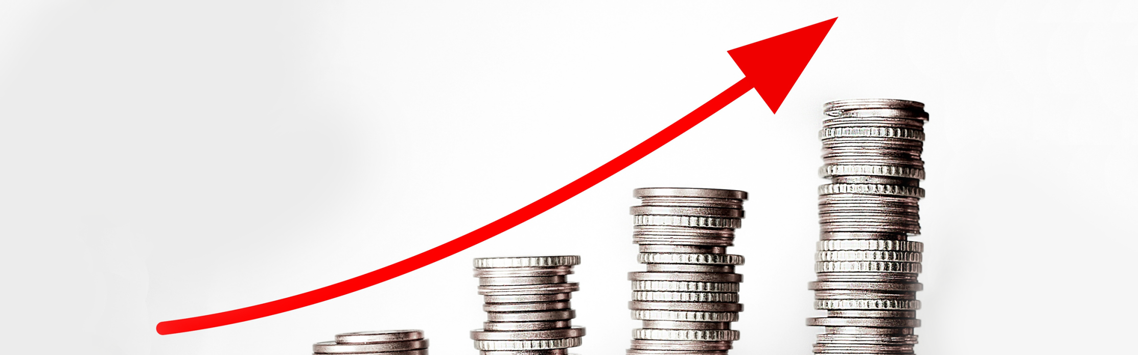Stacks of coins increasing in height with a red upward arrow.