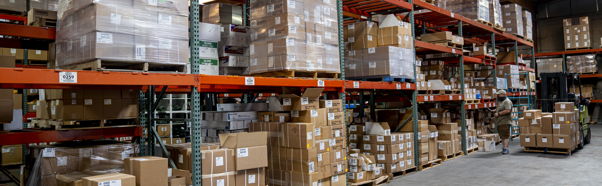 A warehouse with shelves of labeled boxes.