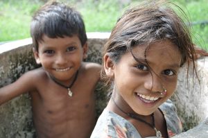 a photo of a young boy and girl siblings sitting together