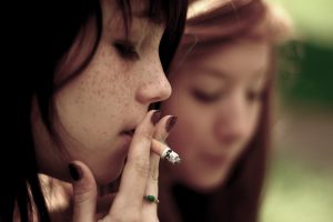 Photo of a teen girl smoking.