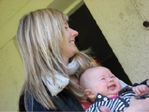 A person is shown holding a happy infant