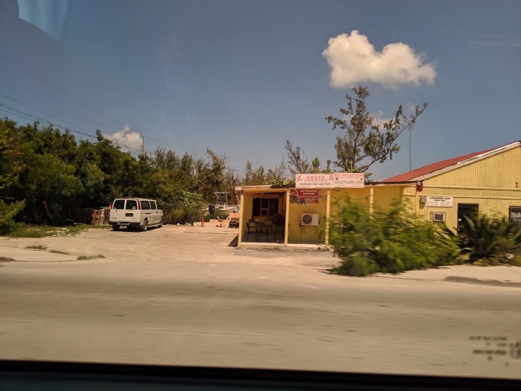 A photo of an impoverished home along a road