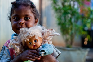 a young girl holding a doll