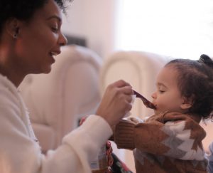 photo of a women feeding her child