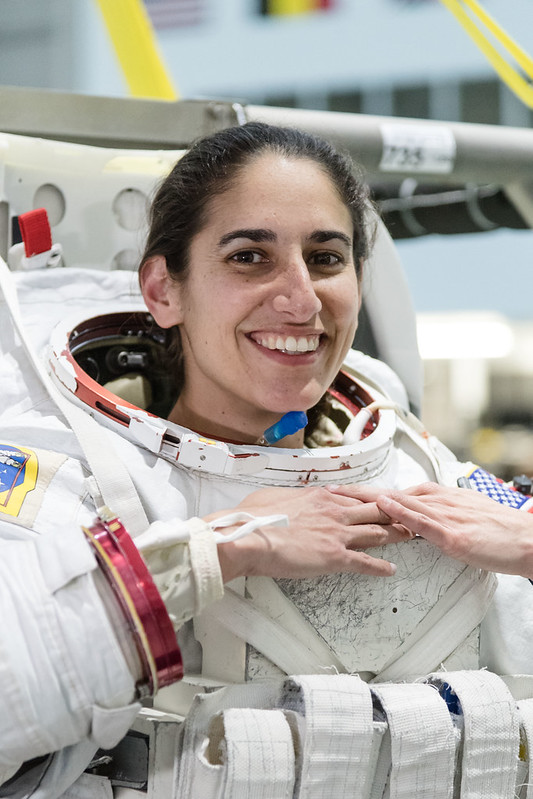 A smiling astronaut with her helmet off.
