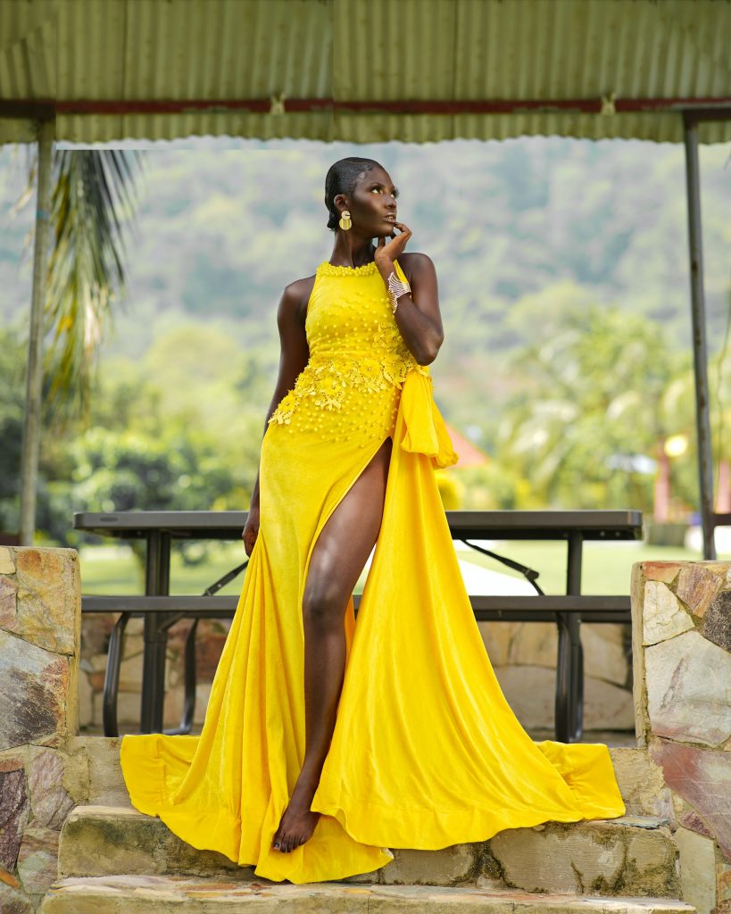 A woman wearing a high-end yellow dress and looking away from the camera.