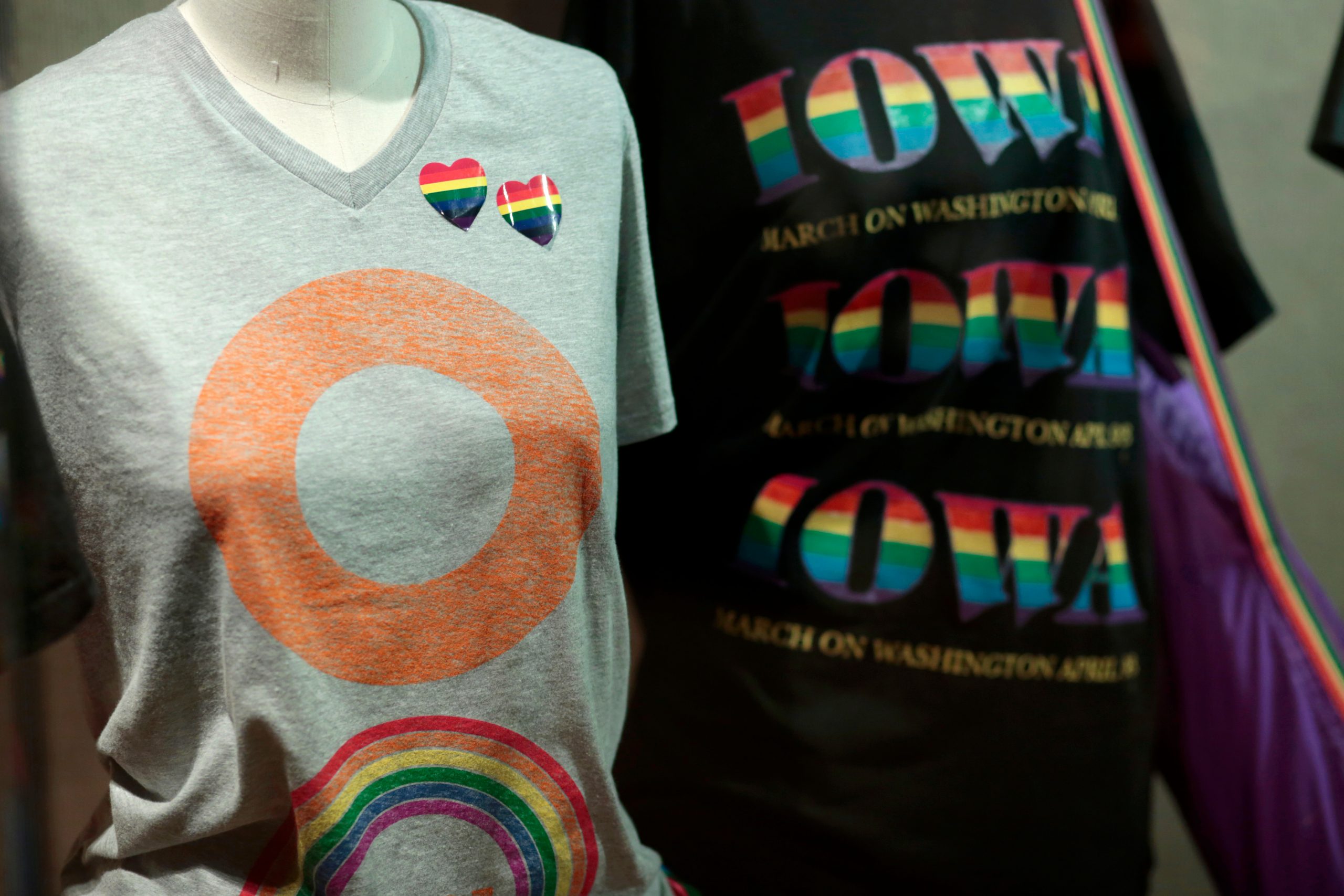 Two t-shirts from "Overtly Proud" showcased on dress forms.