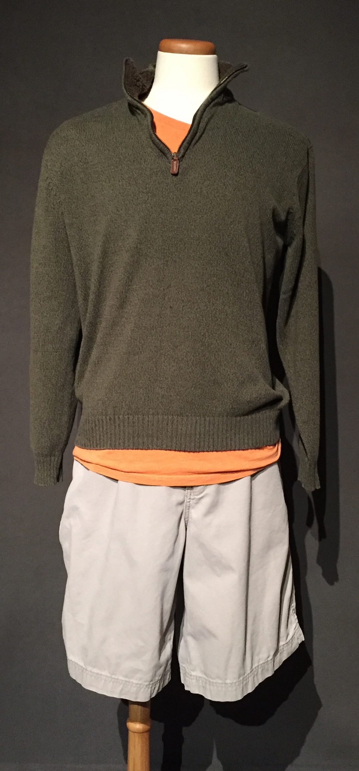 Green pullover turtleneck sweater, orange t-shirt, tan cargo shorts