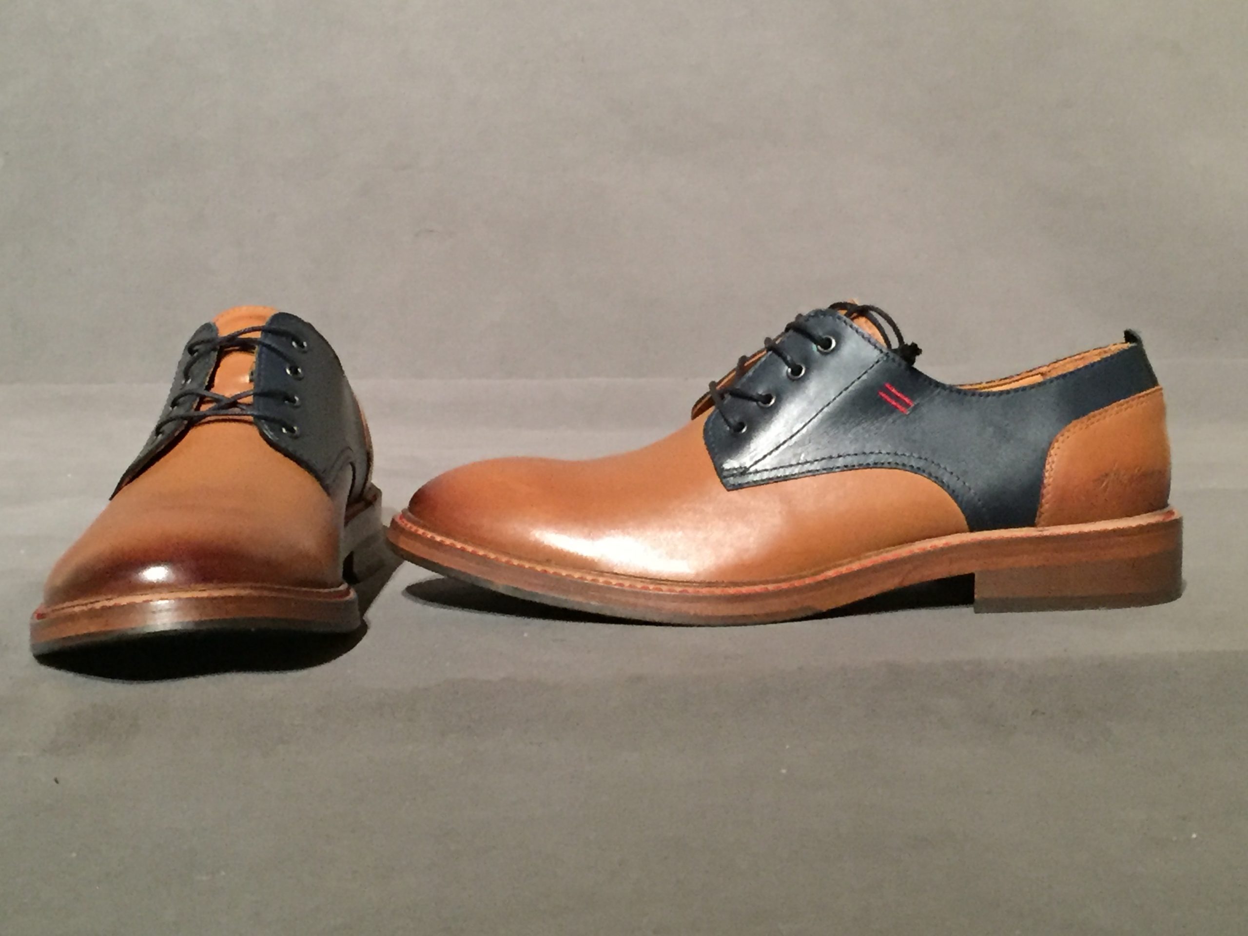 Front and side view of two-tone brown and navy oxford shoes