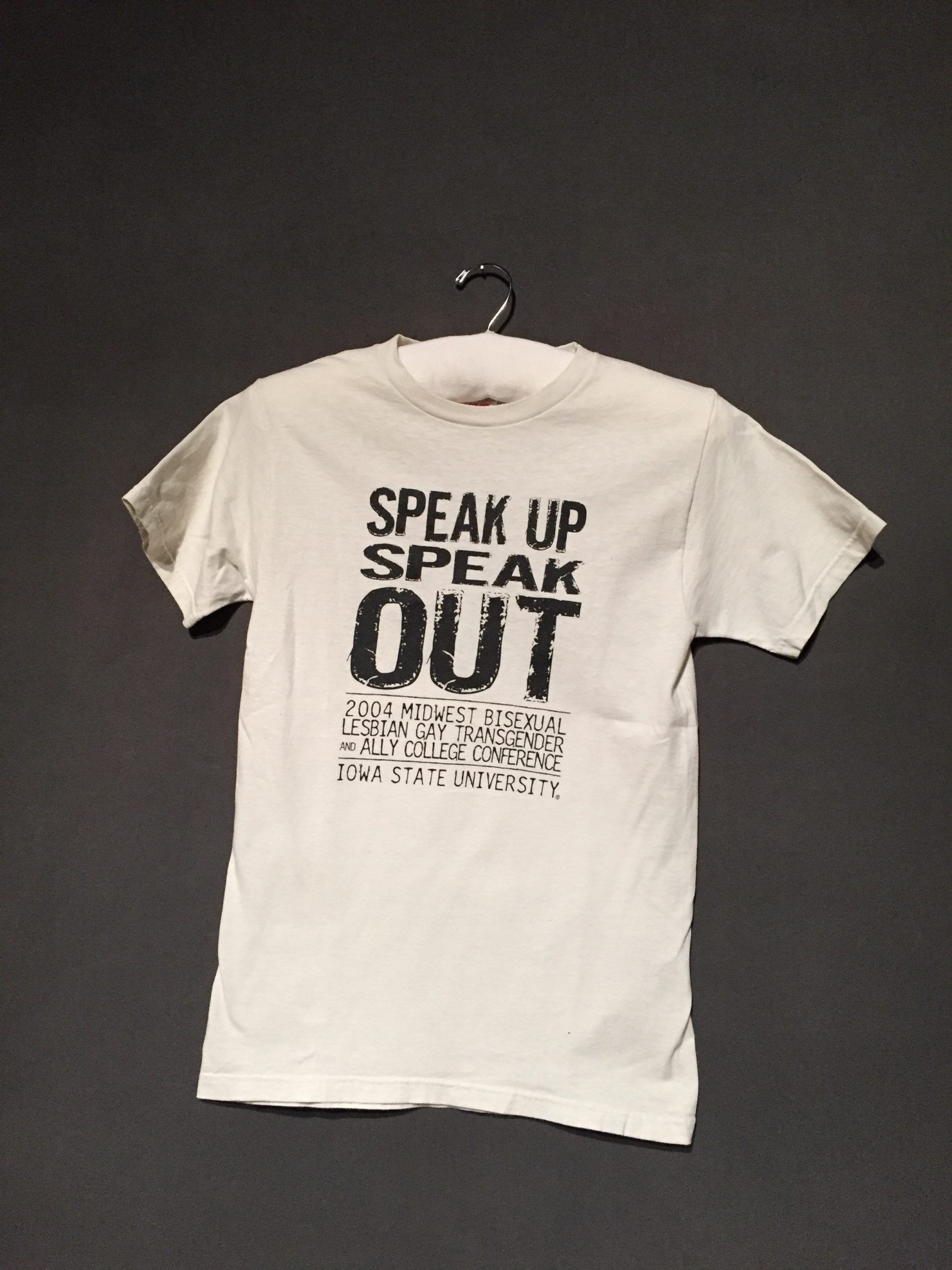 White short sleeve t-shirt with black text reading: "Speak Up Speak Out: 2004 Midwest Bisexual Lesbian Gay Transgender and Ally College Conference, Iowa State University"