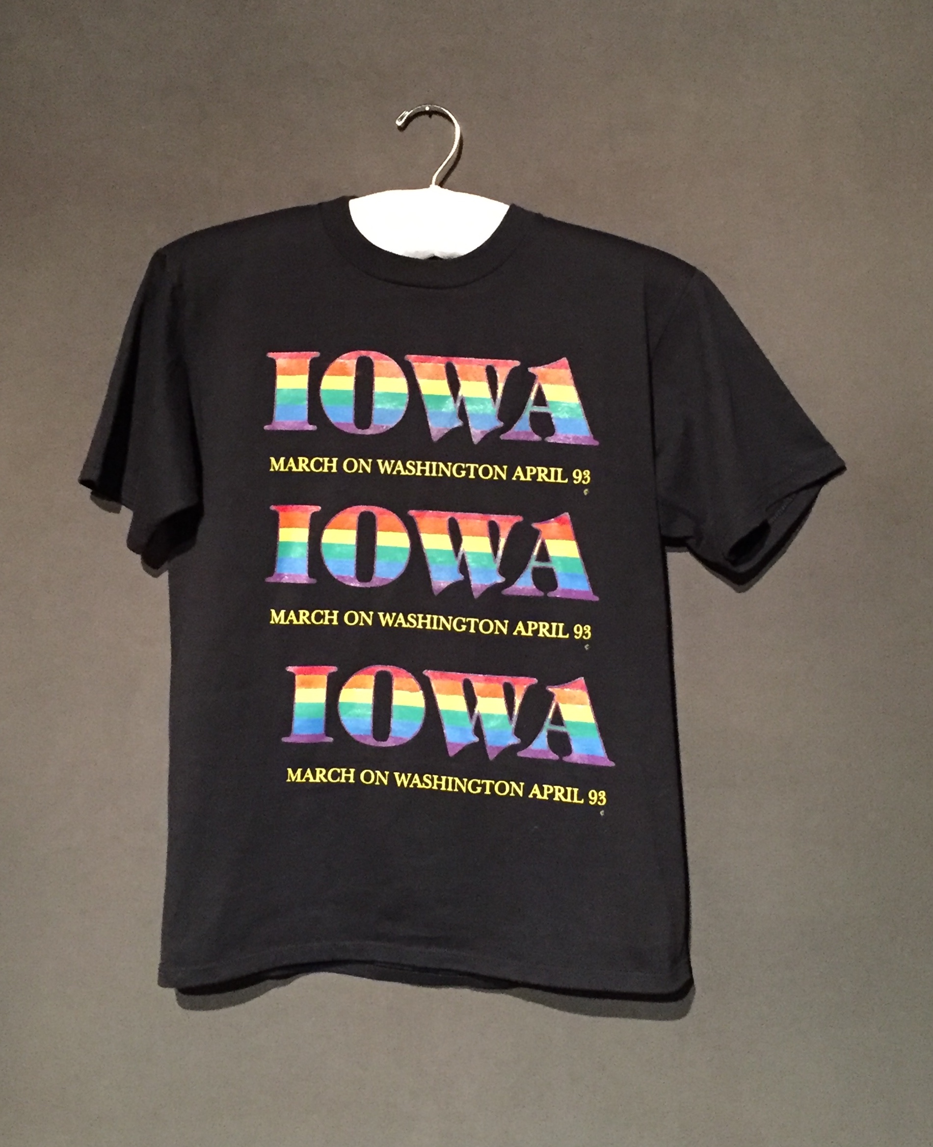 Black short sleeve t-shirt with rainbow lettering reading: "Iowa: March on Washington 93"