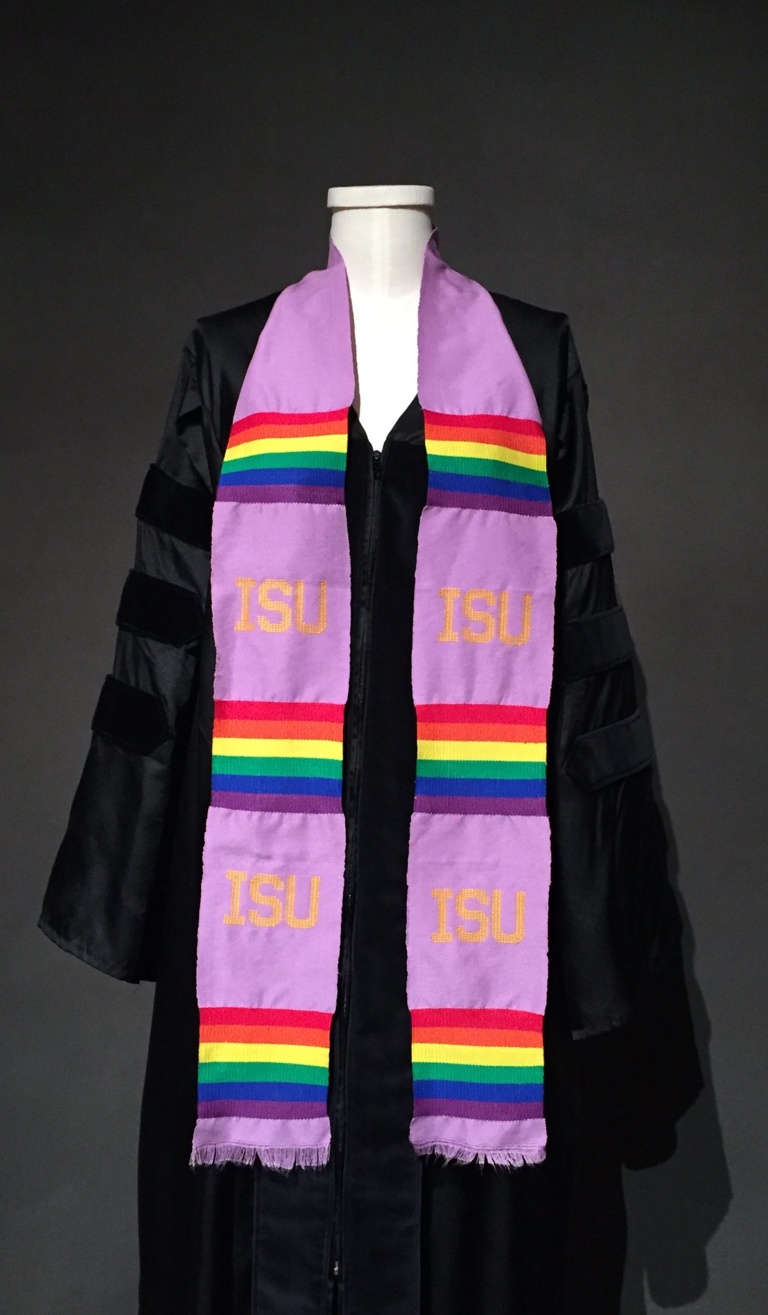 Black graduation robe, lavender graduation stole with ISU motif and rainbow bands
