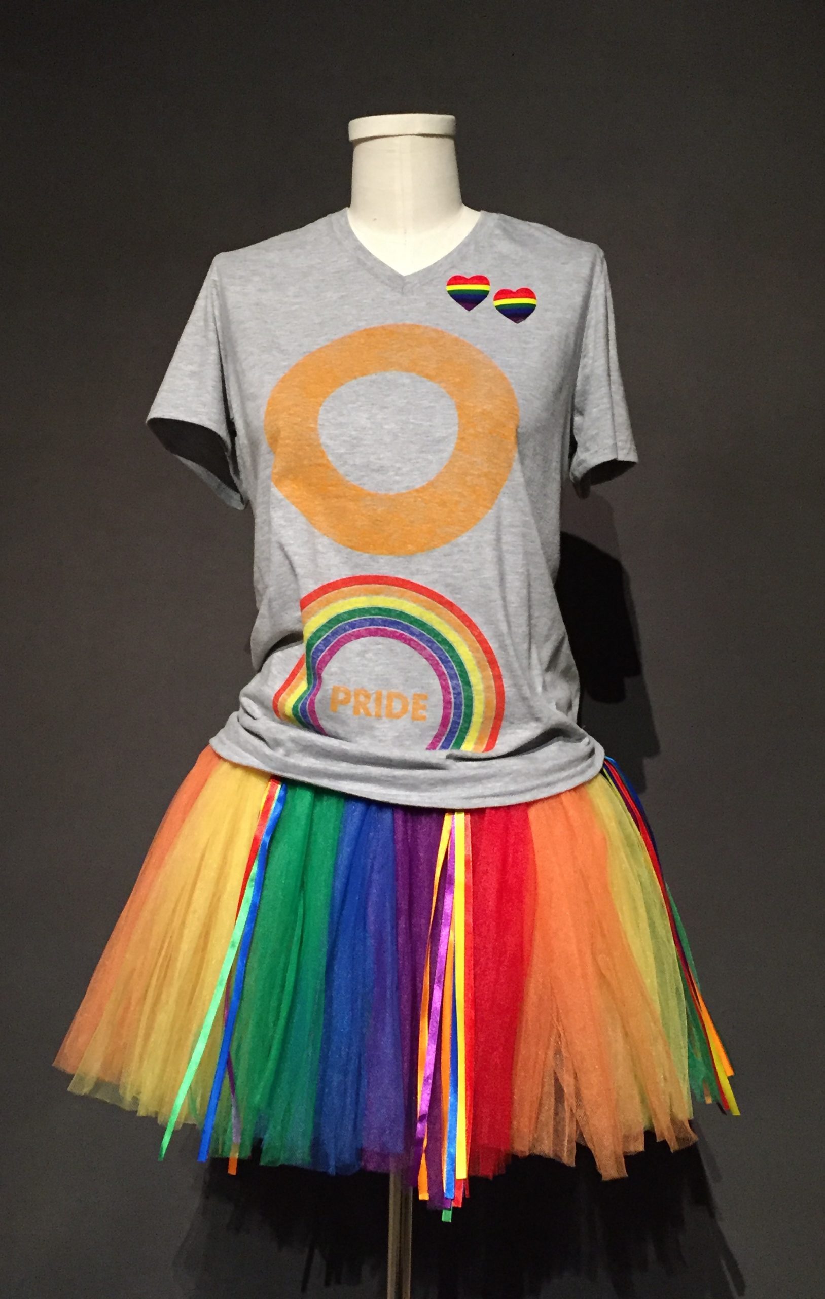 Gray short sleeve t-shirt with orange and rainbow rings paired with rainbow tutu