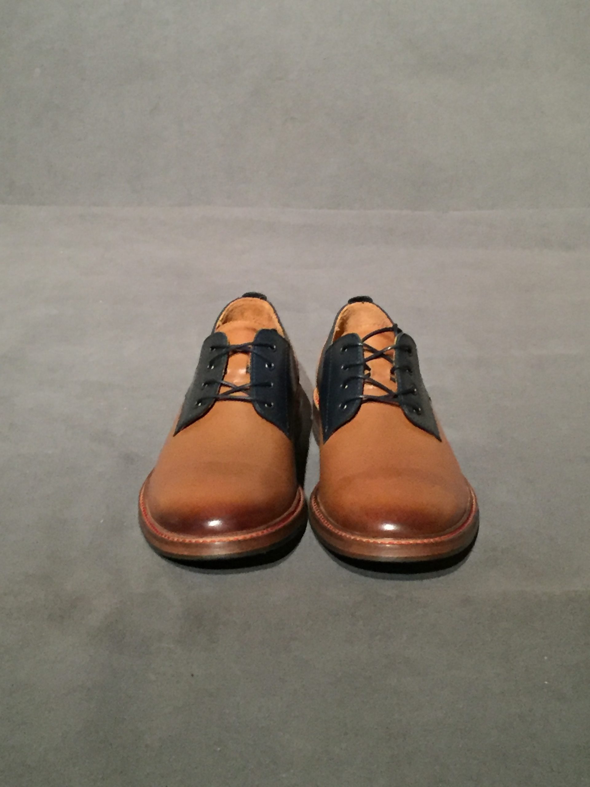Front view of two-tone brown and navy oxford shoes