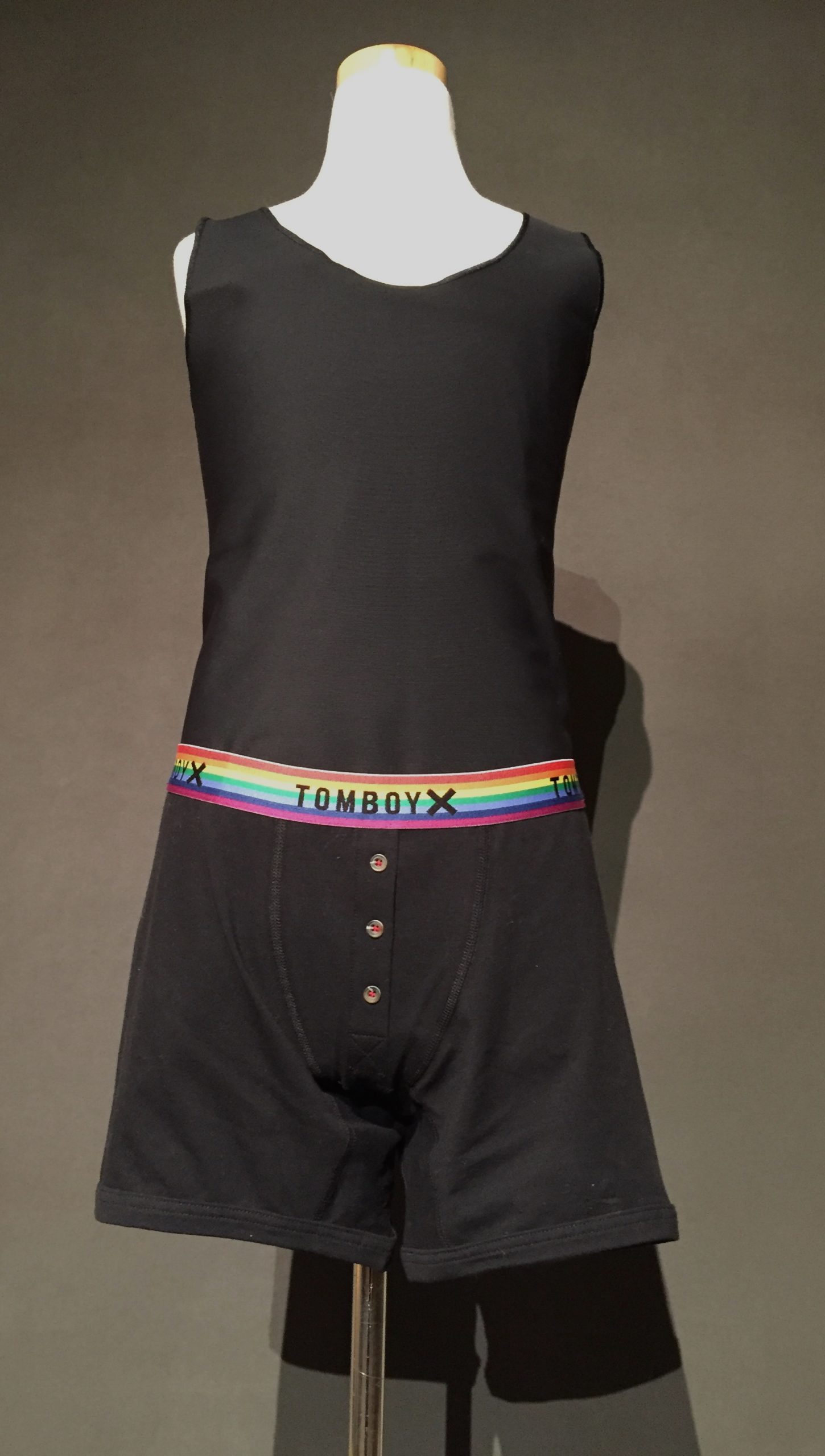 Black binder and black boxer briefs with rainbow waistband reading "TomboyX"