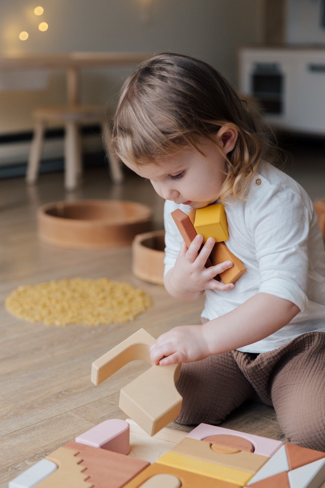 A toddler playing with blocks