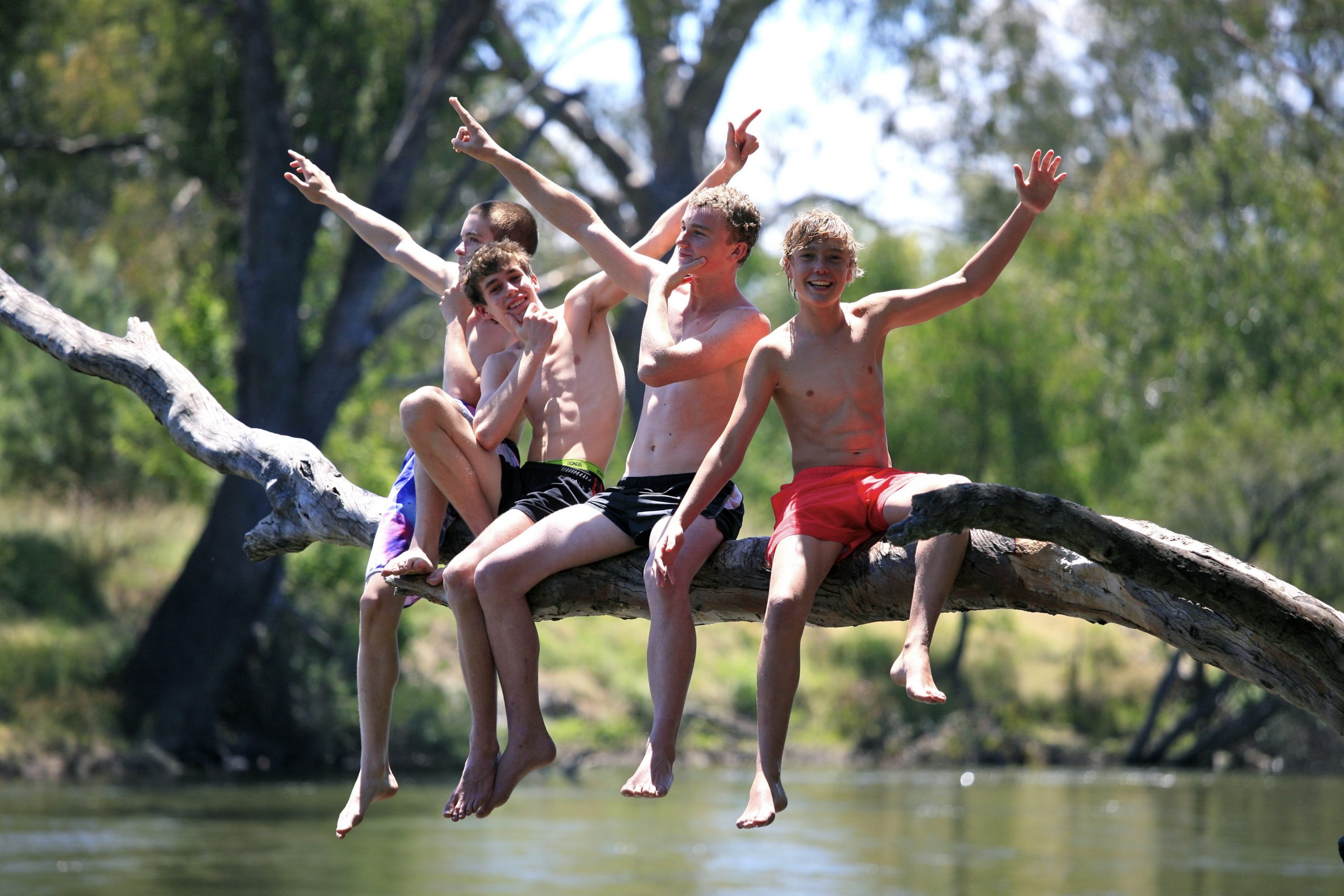Teenagers playing at a lake.
