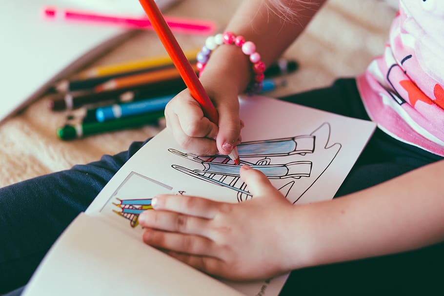 A photo of a child coloring in a coloring book