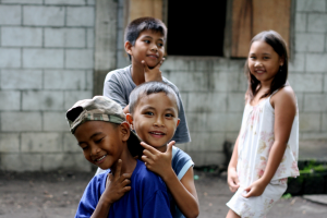 Photo of children gesturing at the camera and posing.