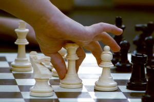 Photo of a child playing chess.