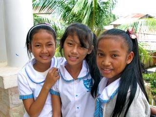 Photo of three girls smiling.