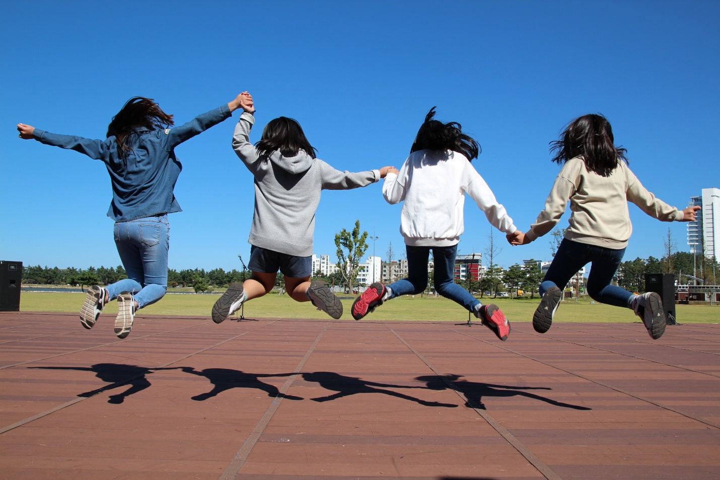 Photo of teenage girls jumping.
