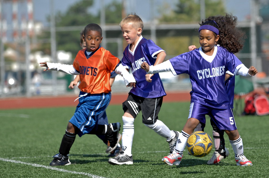 Photo of children playing soccer.