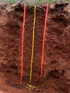Deep red soil extends over 130 cm deep without significant change in color, thin rooted layer at the surface.