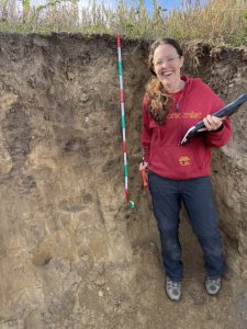 Amber standing in a soil pit.
