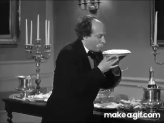 Larry takes a bit of cream pie without a fork