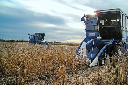 Figure shows a single-row plot harvesters in a mature soybean field.